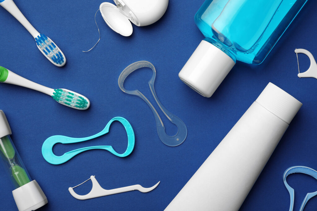 Flat lay composition with tongue cleaner on color background